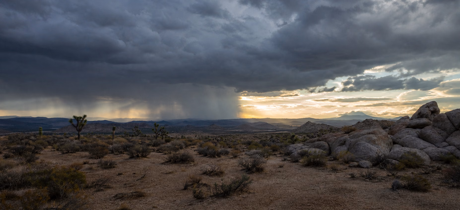A clearing summer storm above granite formations in Joshua Tree National Park